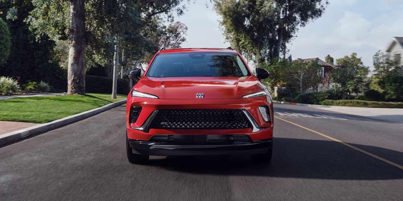 Red 2026 Buick Envision driving down road