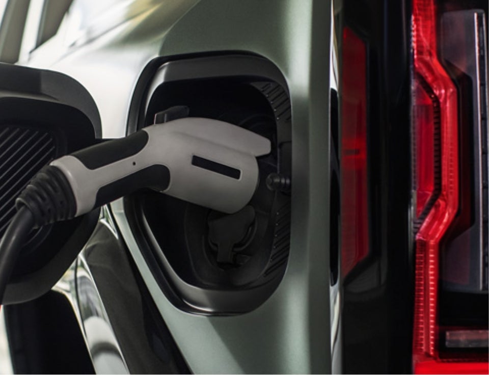 Close up of charging port with charger plugged in on a GMC Hummer EV SUV - Yates Buick GMC in Goodyear AZ
